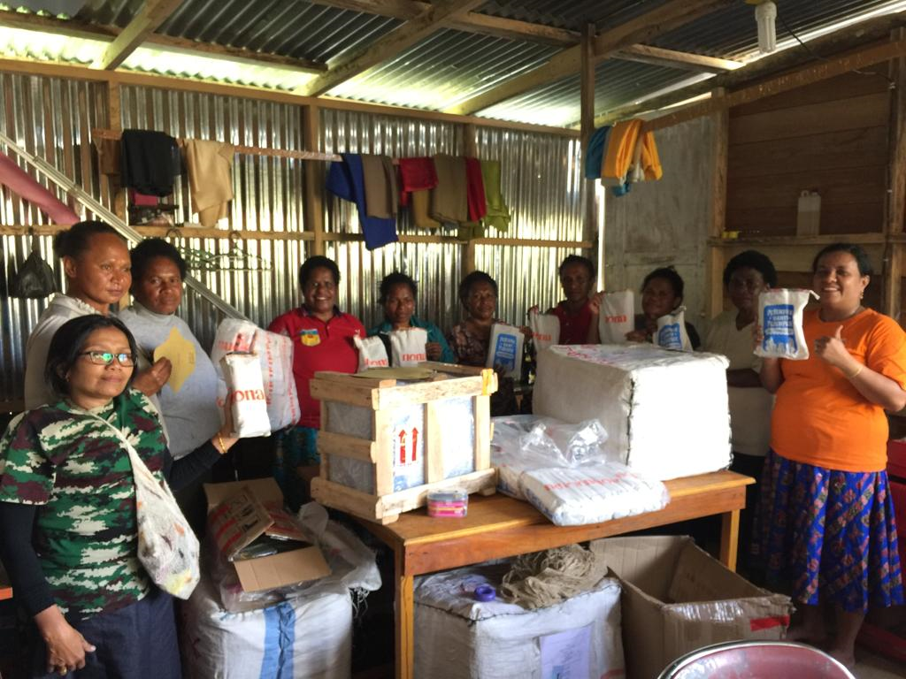 A community of women in Papua receiving menstrual care products from Nona Woman